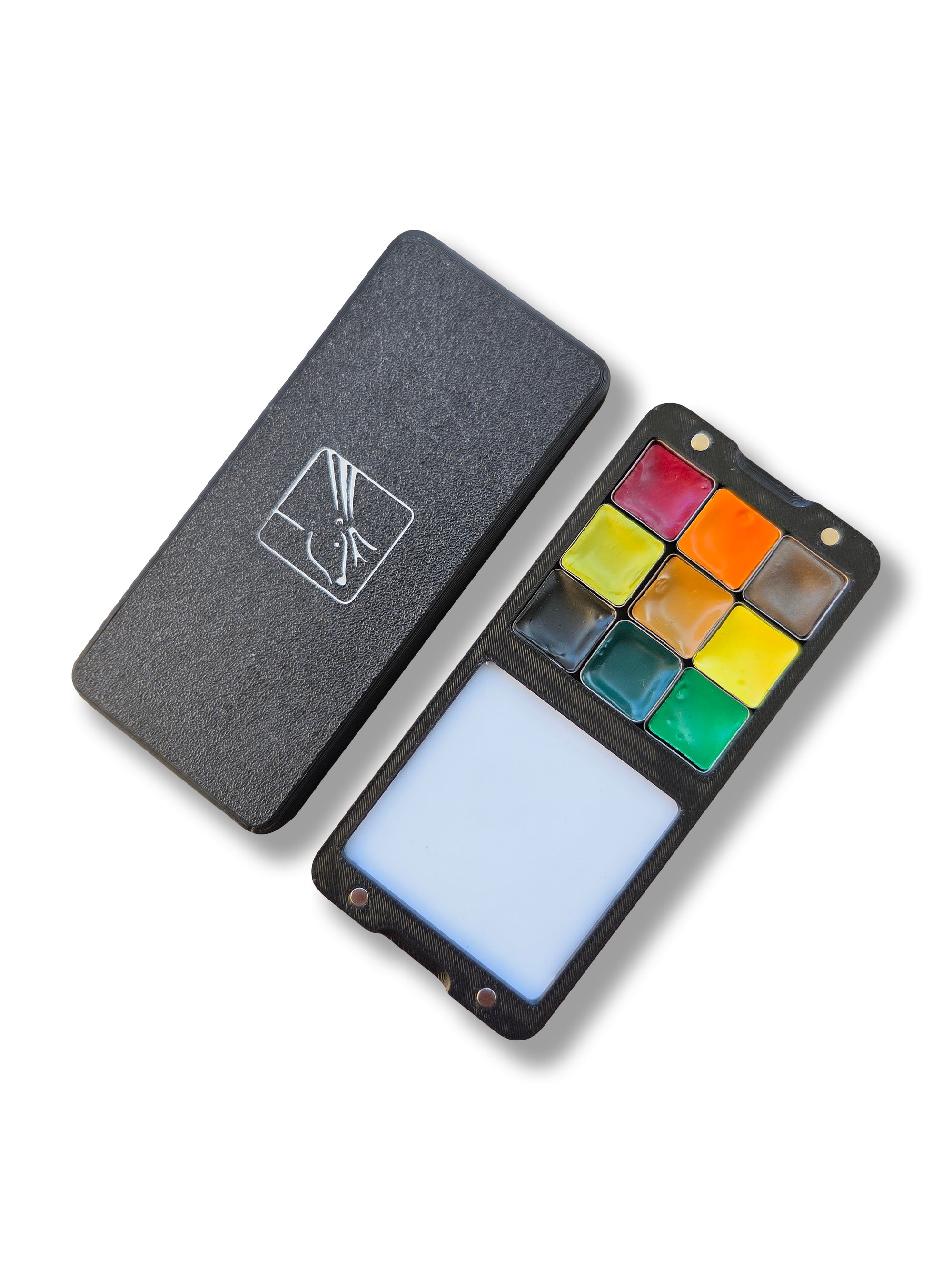 Two halves of an Arwil Art and Design Classic palette on a white background, watercolour paint pans half full