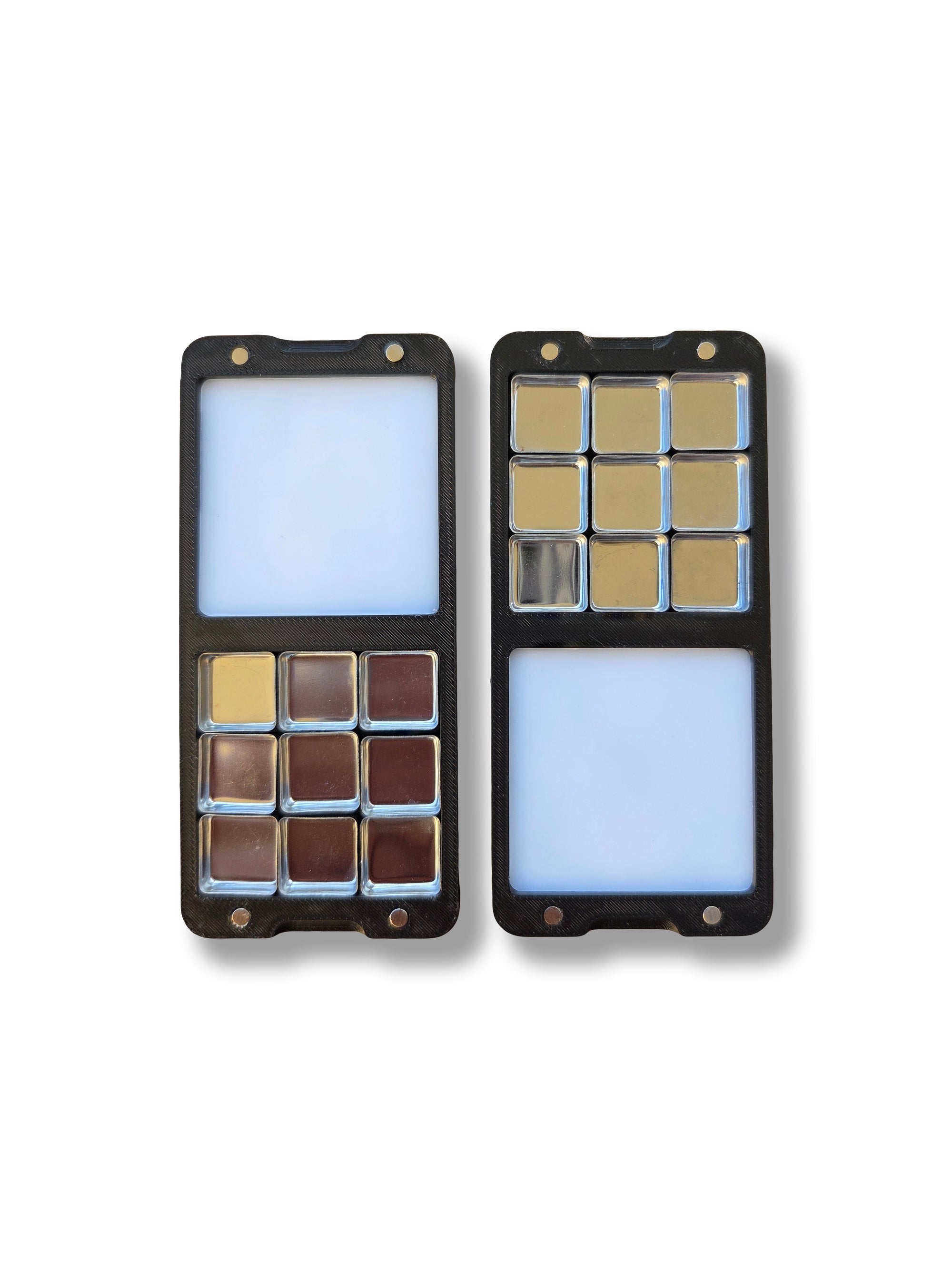 Two halves of an Arwil Art and Design Classic palette on a white background, watercolour paint pans empty