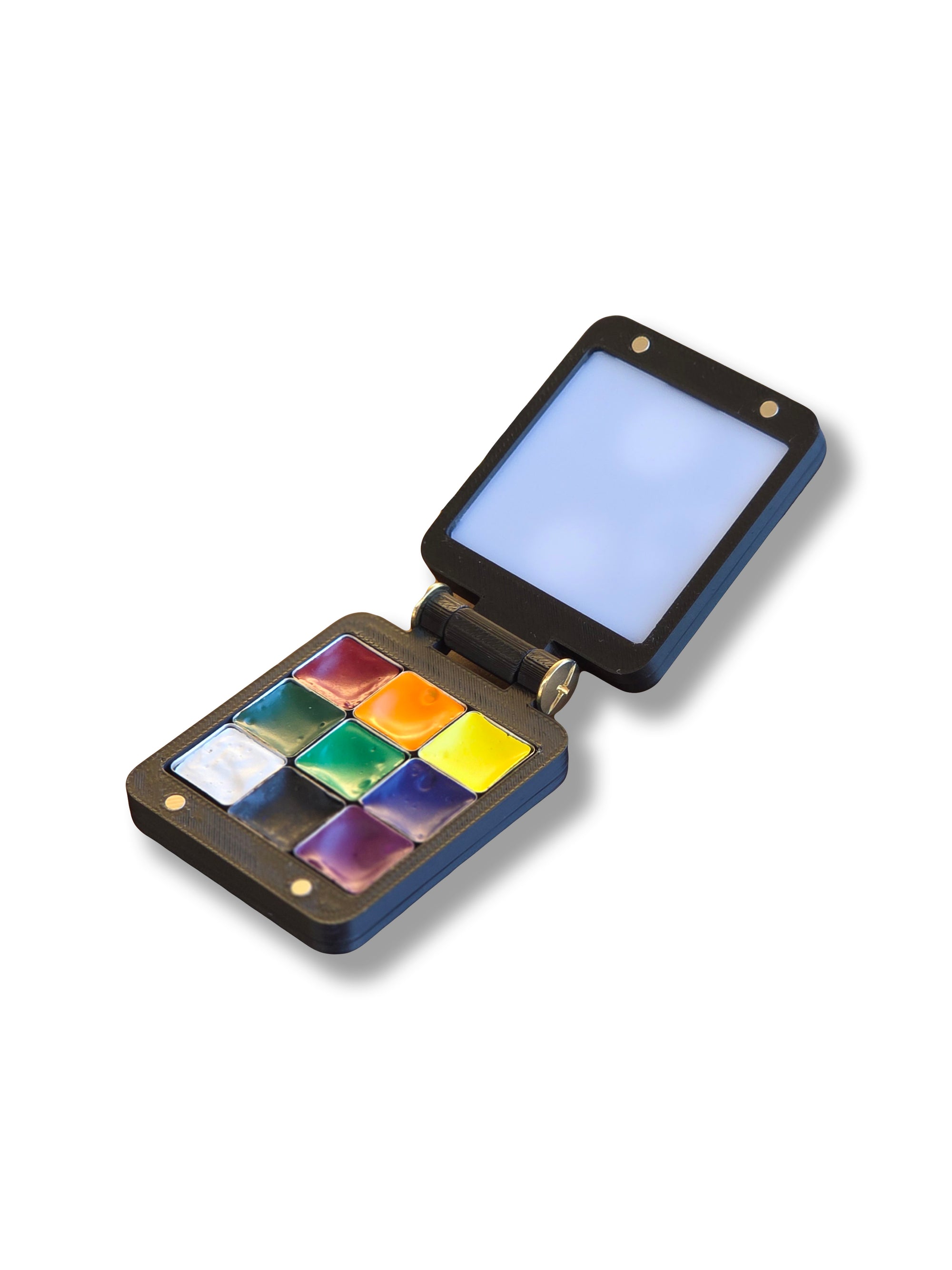 An open Arwil Art and Design Pocket Palette on a white background, watercolour paint pans full