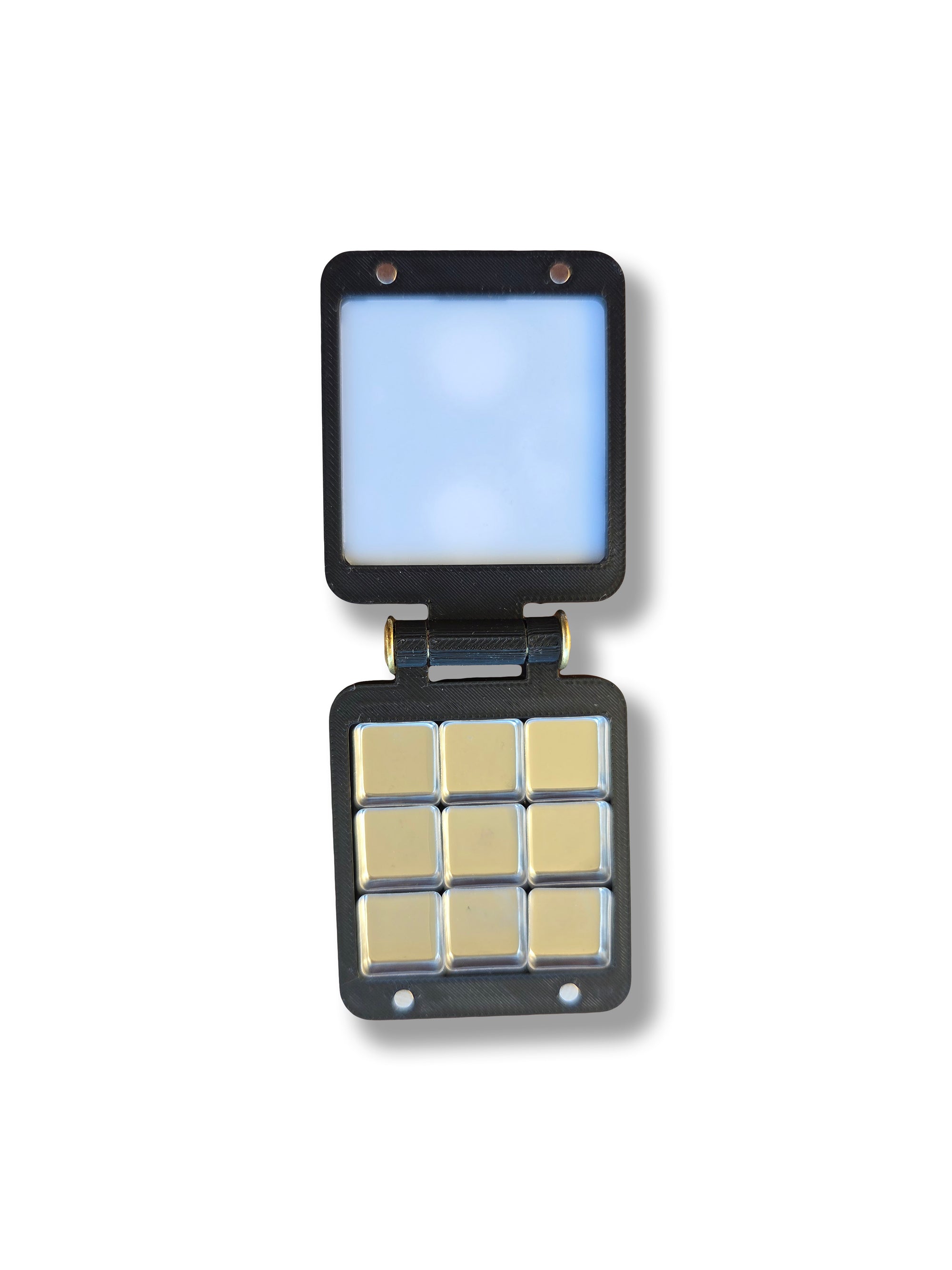 An open Arwil Art and Design Pocket Palette on a white background, watercolour paint pans empty